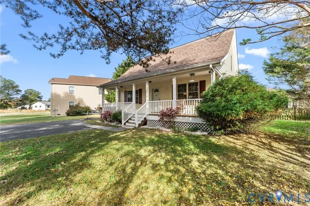 a view of a house with backyard sitting area and garden