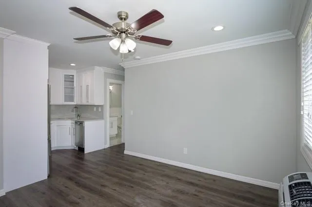 a view of a kitchen with a sink and a refrigerator