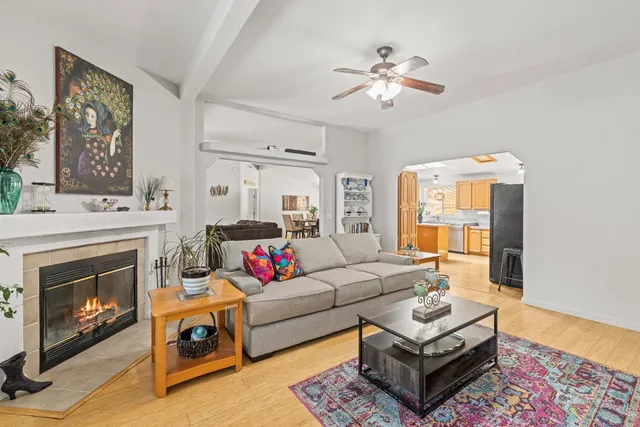 a living room with furniture a fireplace and a flat screen tv