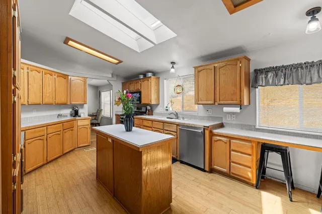 a kitchen with granite countertop a sink appliances cabinets and furniture