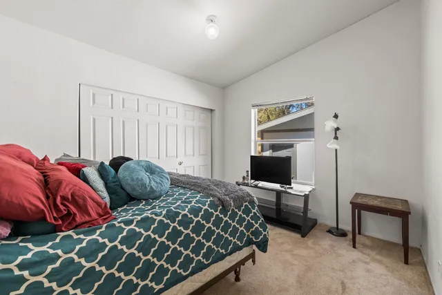 a bedroom with a bed and a tv