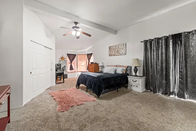 a bedroom with bed and a chandelier