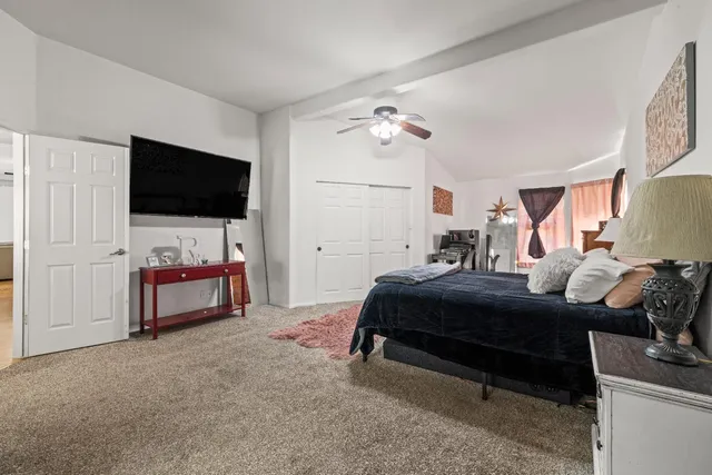 a bedroom with furniture and a flat screen tv