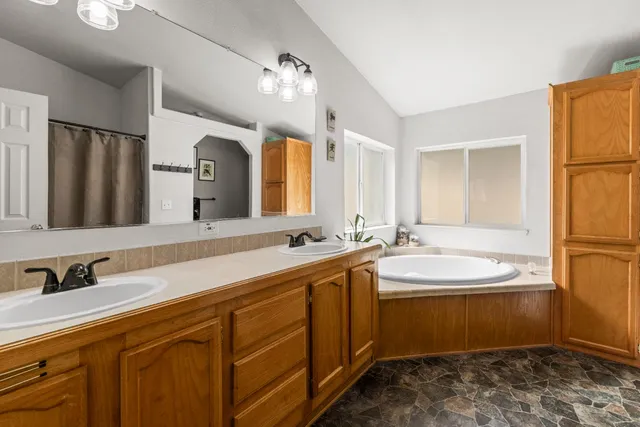 a bathroom with a double vanity sink and mirror