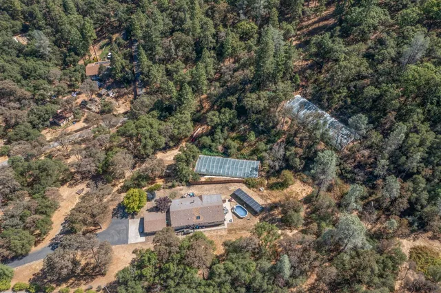 an aerial view of a house with yard and outdoor seating