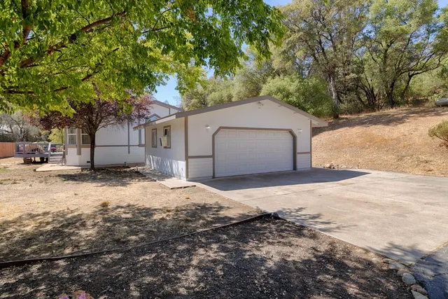a house with a covered with snow next to yard
