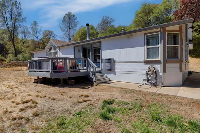 a view of a house with wooden fence