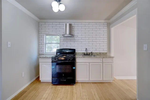 a kitchen with stainless steel appliances a stove a sink and a refrigerator