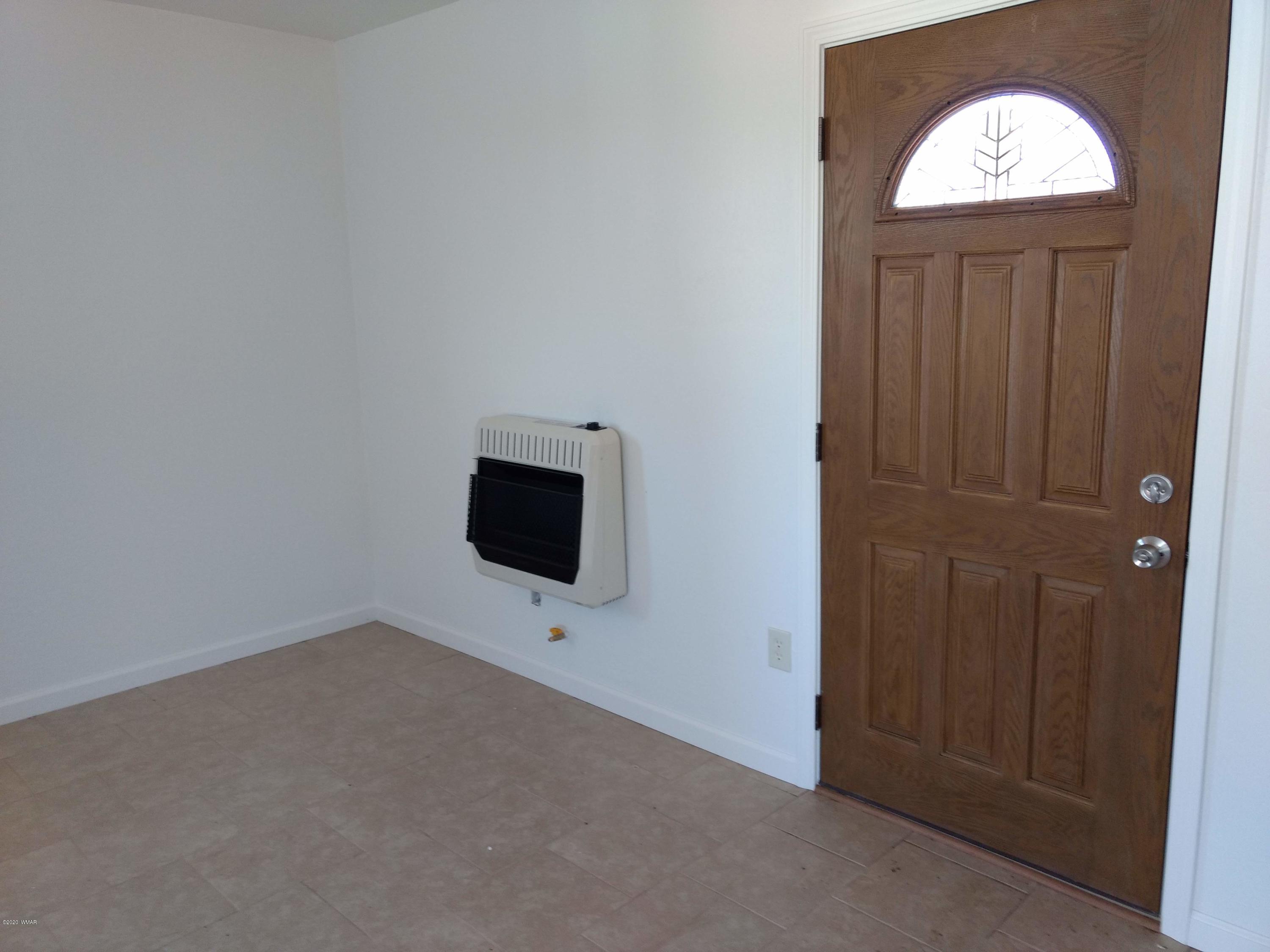 9 County Road Show Low, AZ 85901 - Photo 16 of 46 an empty room with windows cabinet and mirror