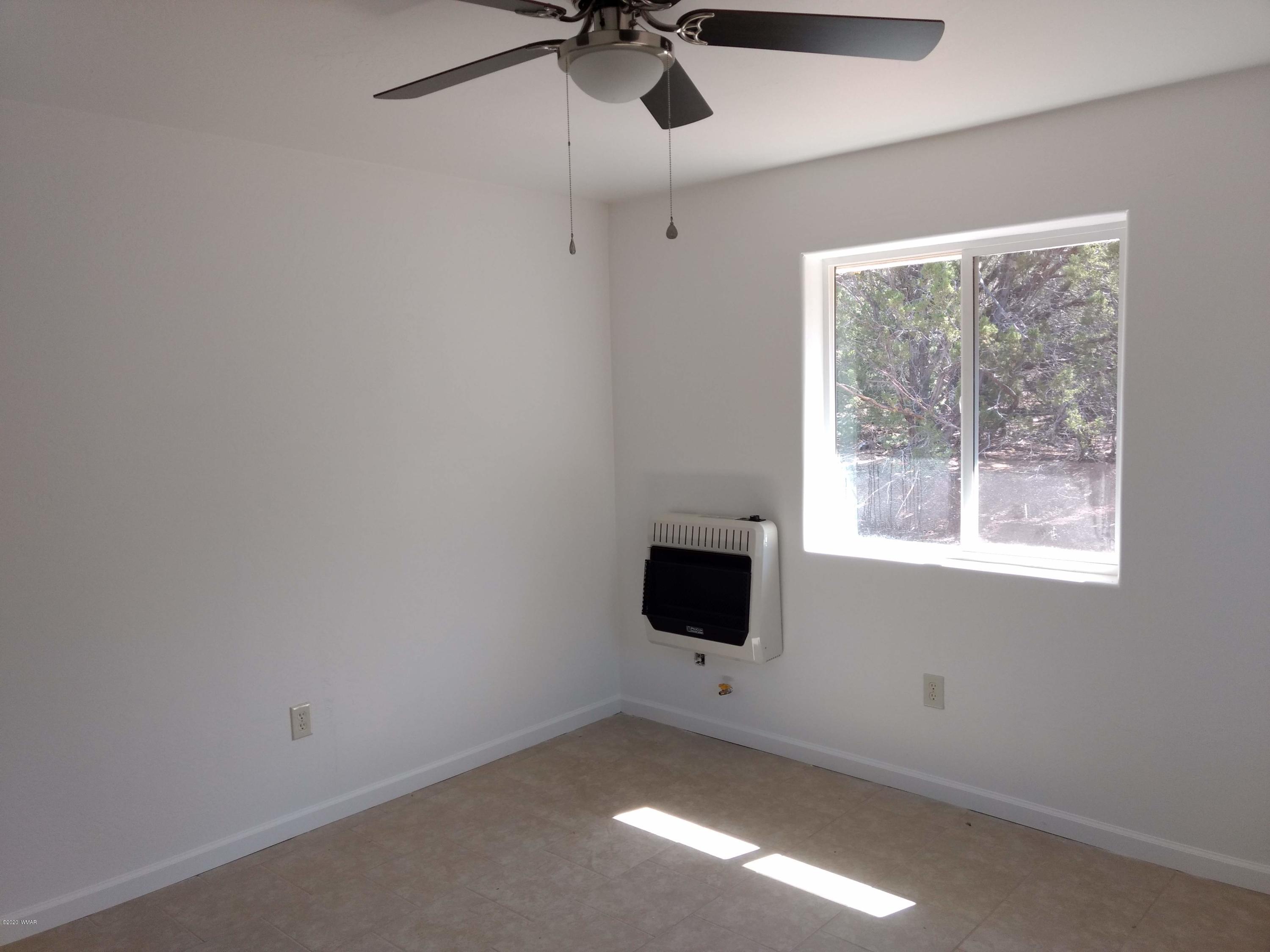 9 County Road Show Low, AZ 85901 - Photo 18 of 46 a view of empty room with a window and a ceiling fan