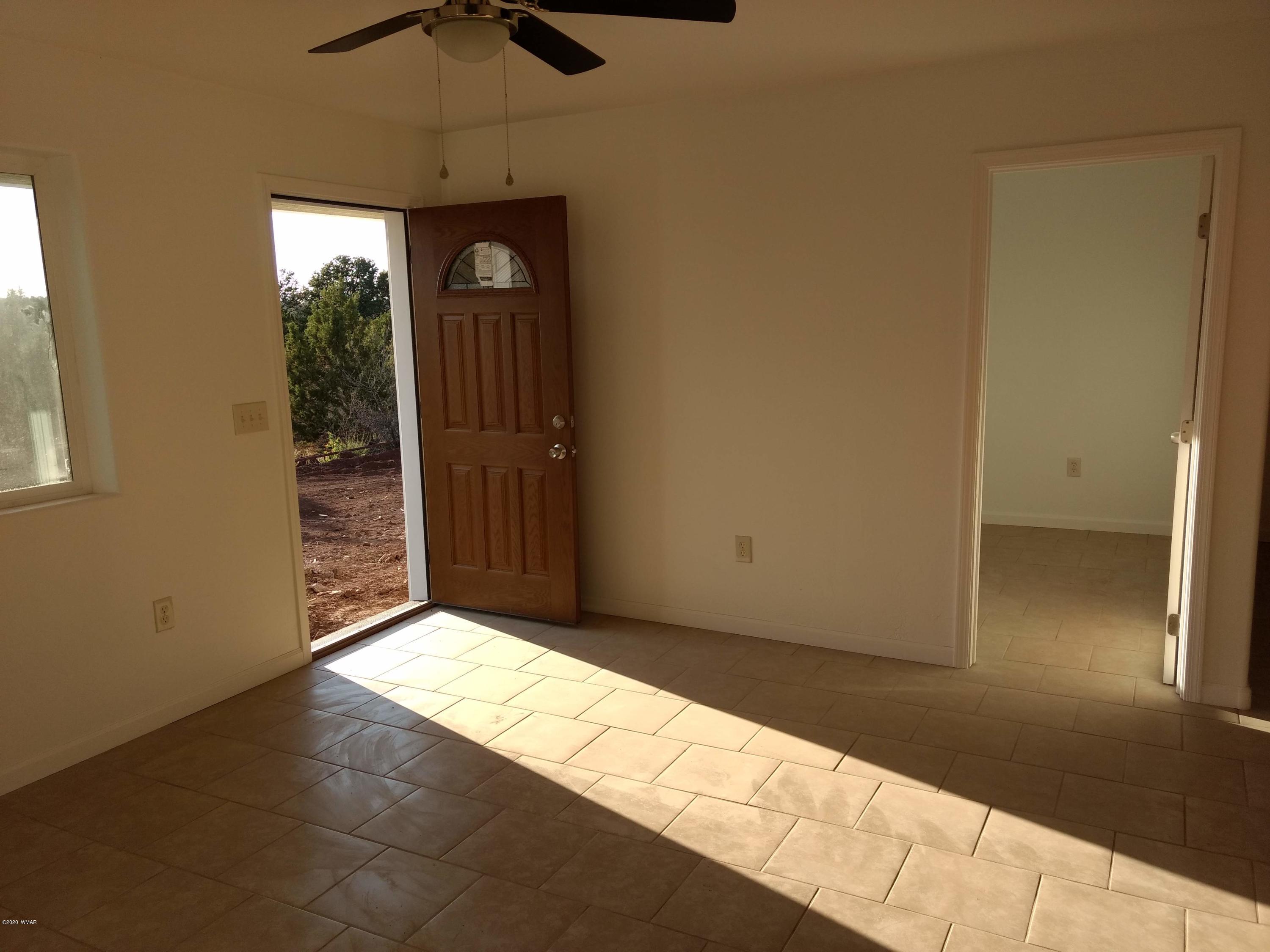 9 County Road Show Low, AZ 85901 - Photo 22 of 46 a view of an empty room with wooden floor and a window