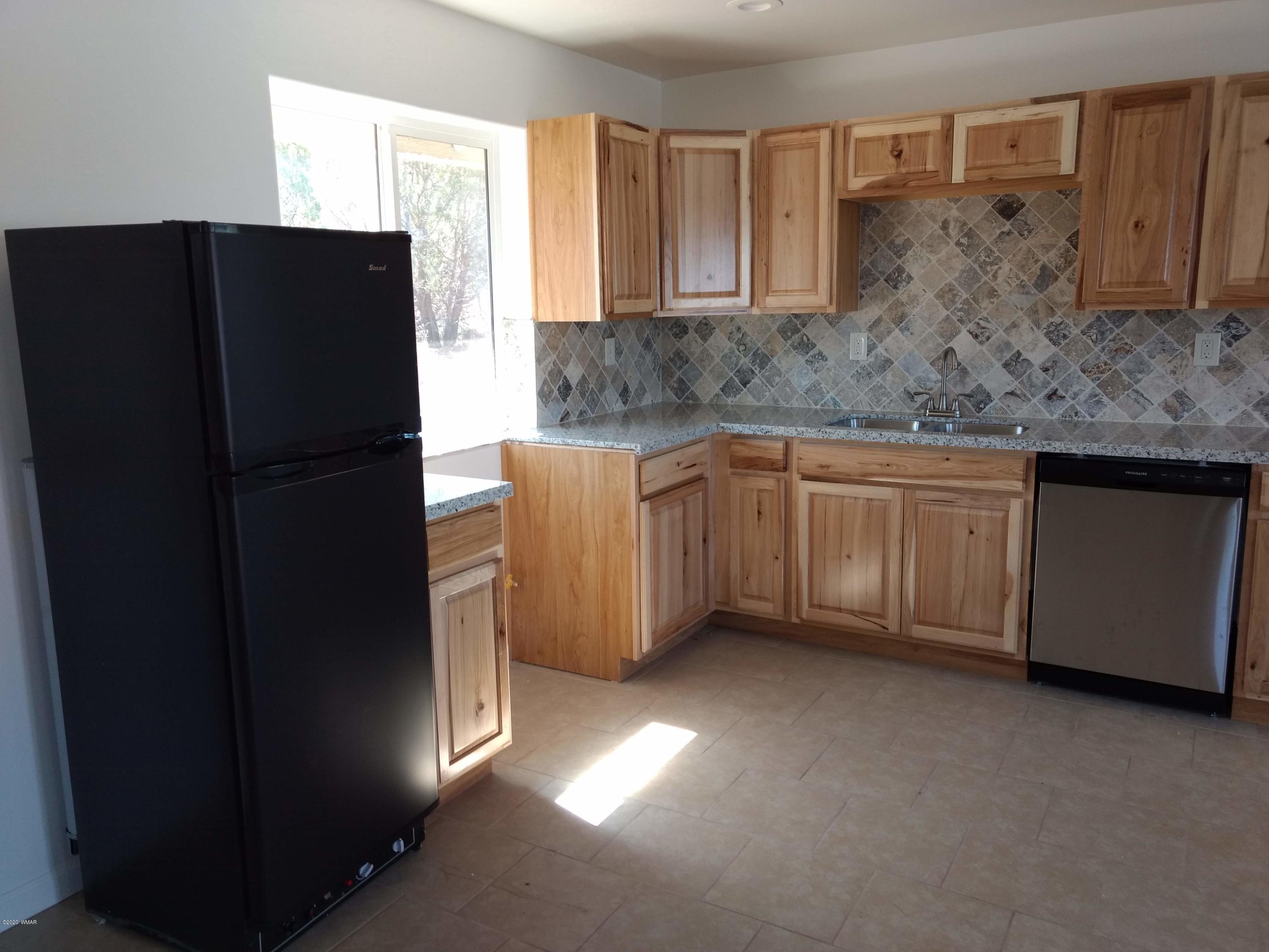 9 County Road Show Low, AZ 85901 - Photo 8 of 46 a kitchen with stainless steel appliances granite countertop a refrigerator and a sink