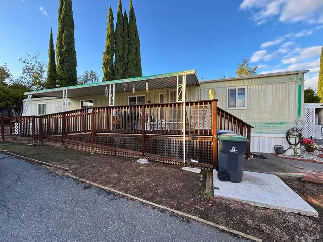 a view of a house with wooden floor roof and wooden fence