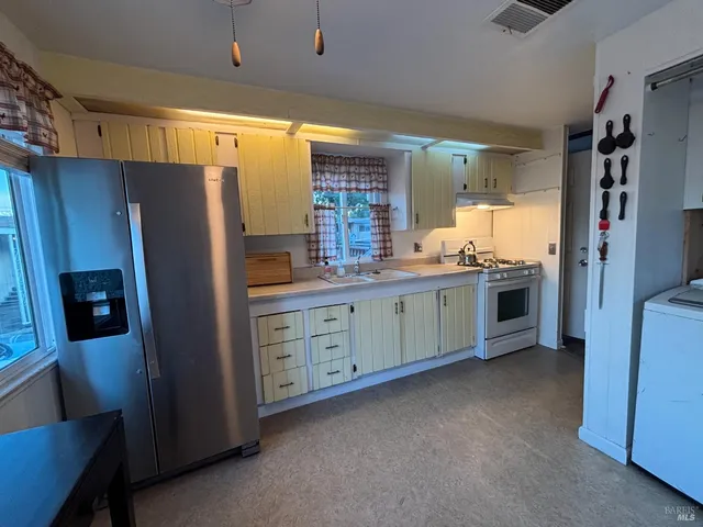 a kitchen with stainless steel appliances a refrigerator and a stove
