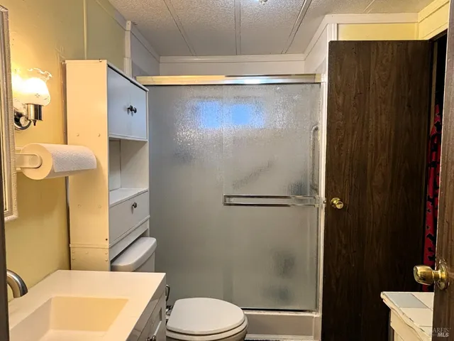 a bathroom with a shower a toilet and a sink