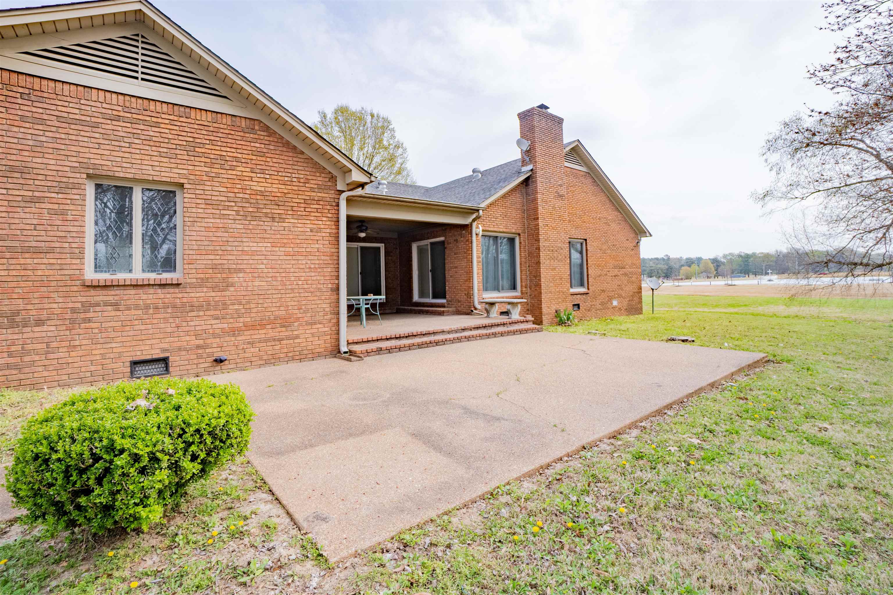 43 Hastings Way Covington, TN 38019 - Photo 3 of 21 a front view of a house with a yard and potted plants