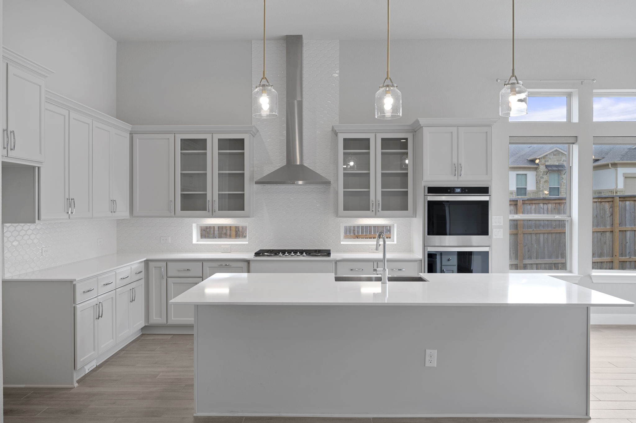 165 Eclipse Drive Austin, TX 78737 - Photo 12 of 38 a kitchen with stainless steel appliances kitchen island granite countertop a sink and a microwave