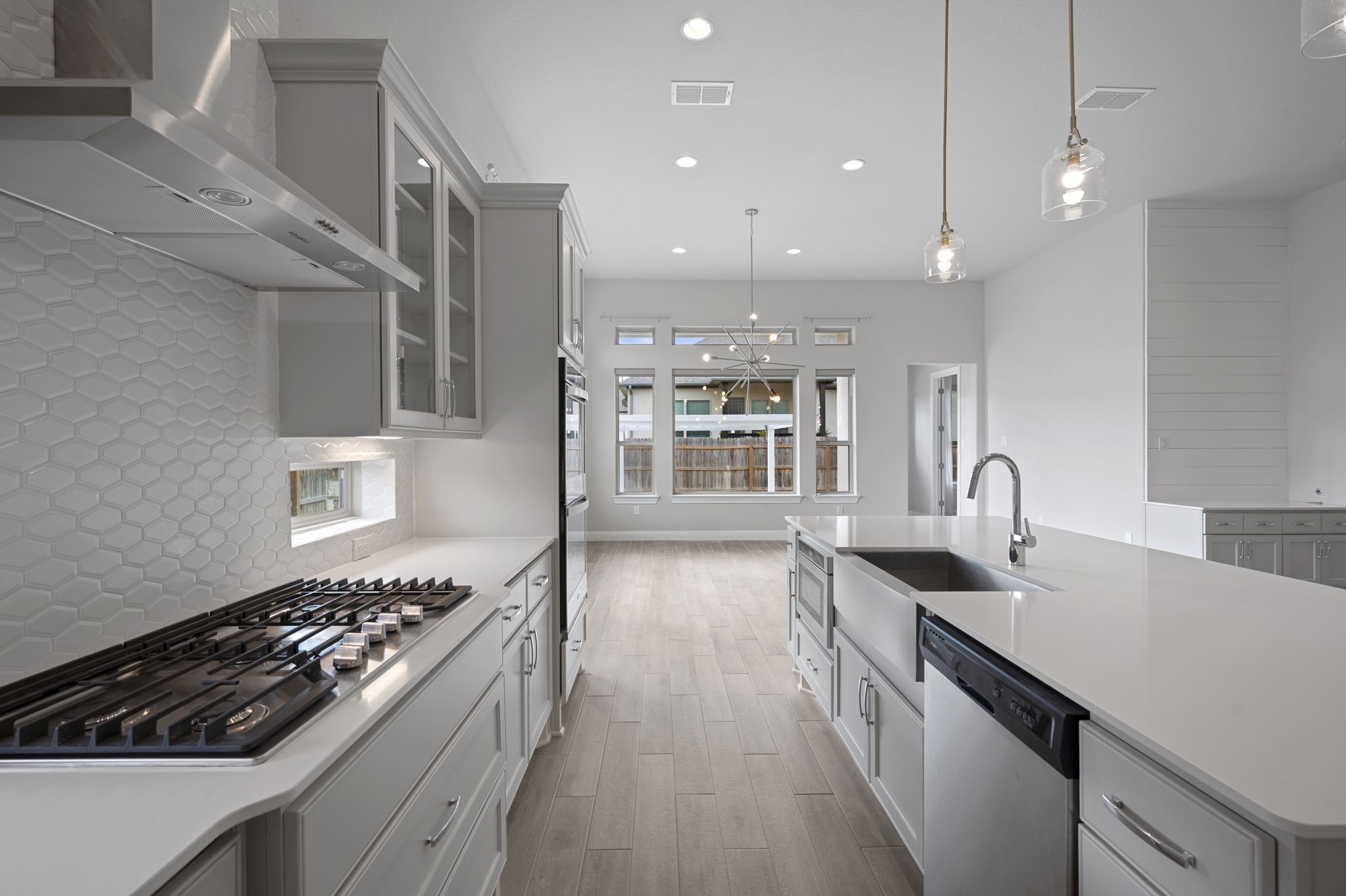 165 Eclipse Drive Austin, TX 78737 - Photo 15 of 38 a kitchen with kitchen island a counter space a sink a stove and wooden floor