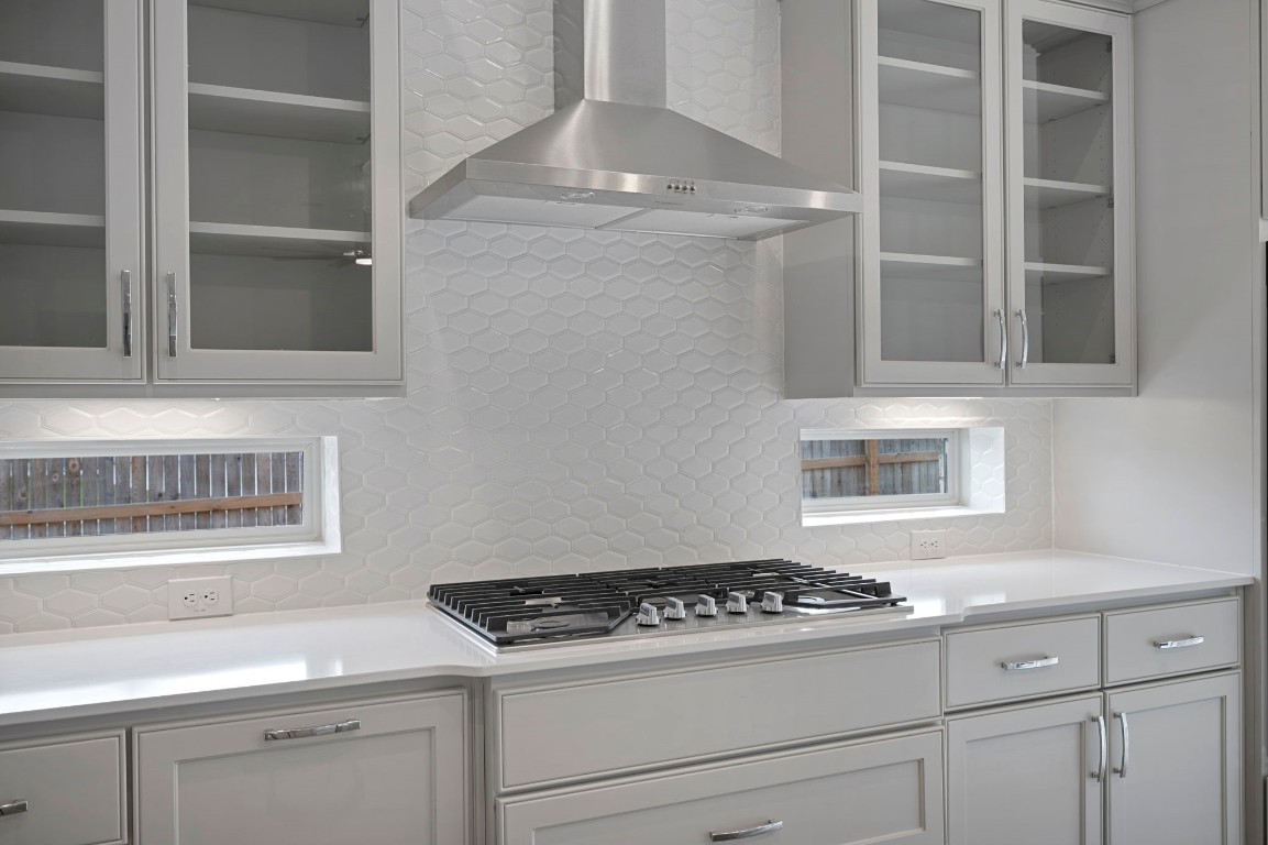 165 Eclipse Drive Austin, TX 78737 - Photo 16 of 38 a kitchen with granite countertop stainless steel appliances a stove and white cabinets