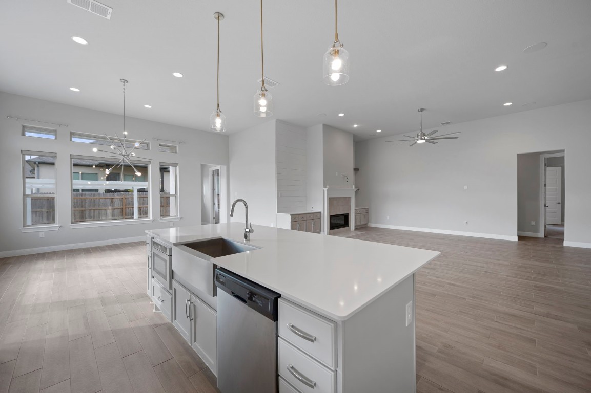 165 Eclipse Drive Austin, TX 78737 - Photo 17 of 38 a large kitchen with kitchen island a sink granite counter tops and a view of living room