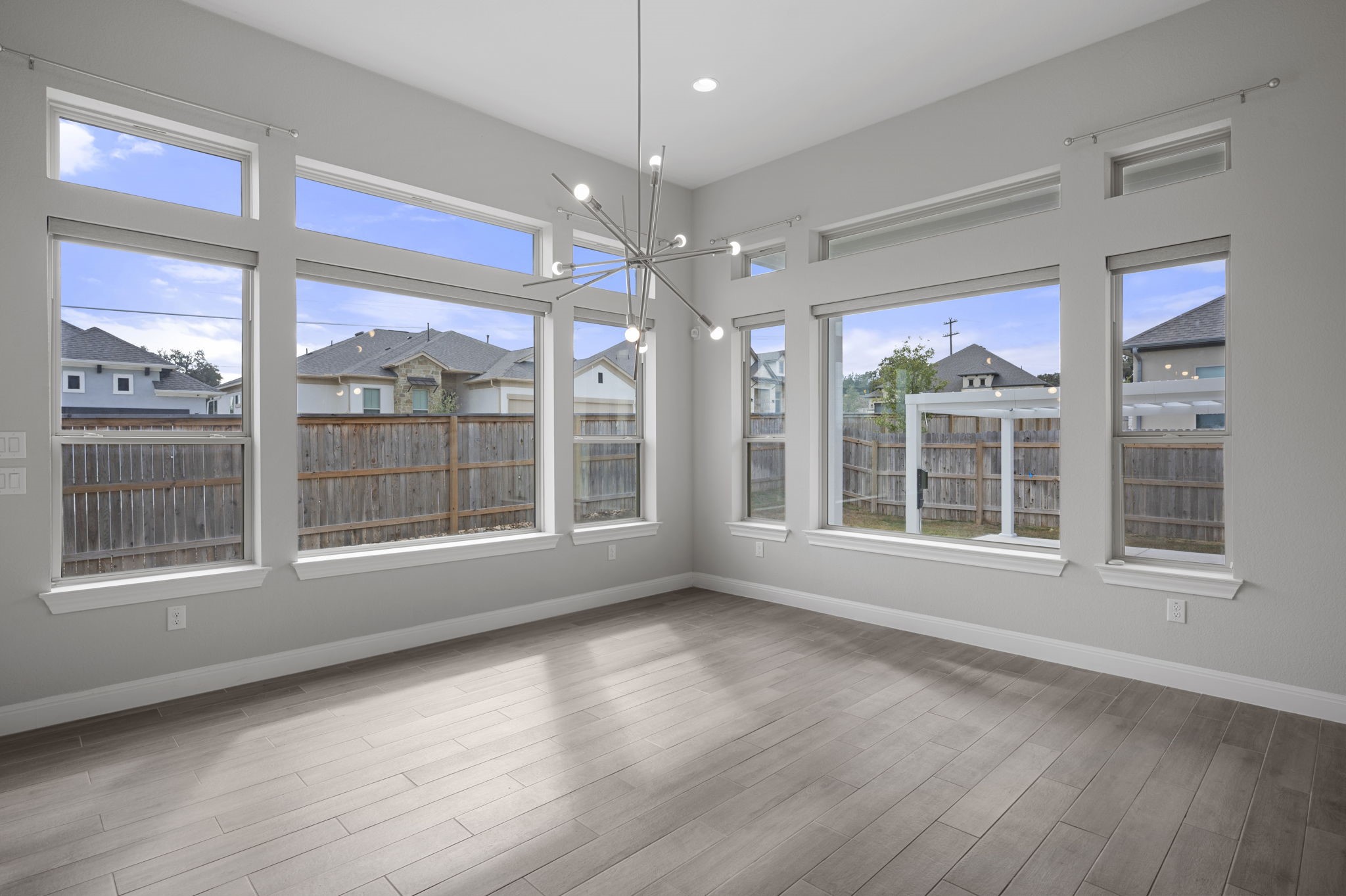 165 Eclipse Drive Austin, TX 78737 - Photo 18 of 38 a view of an empty room with a window and wooden floor