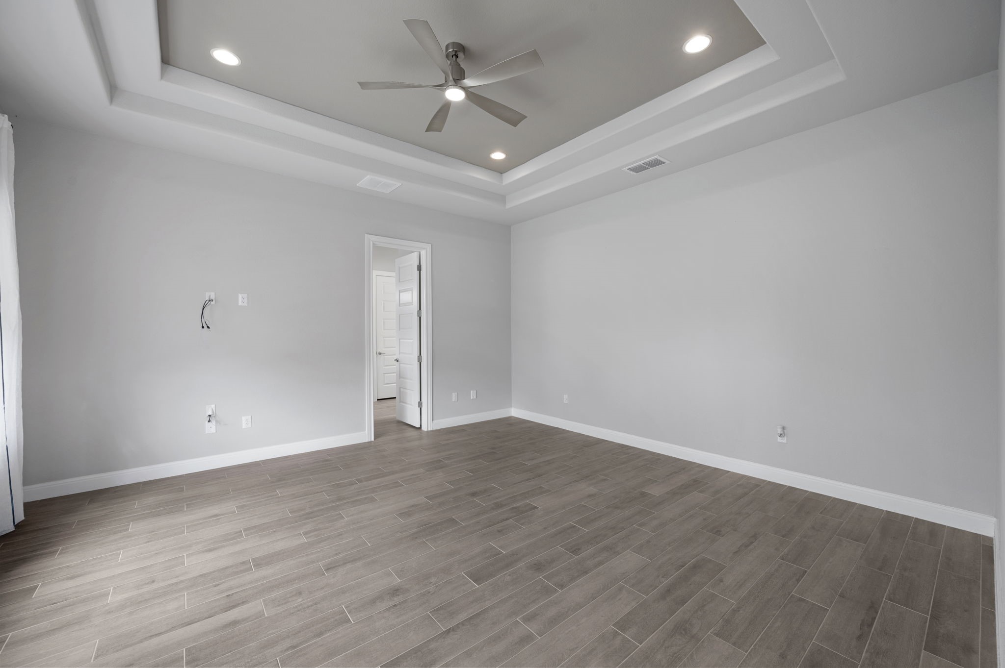 165 Eclipse Drive Austin, TX 78737 - Photo 21 of 38 an empty room with wooden floor and ceiling fan