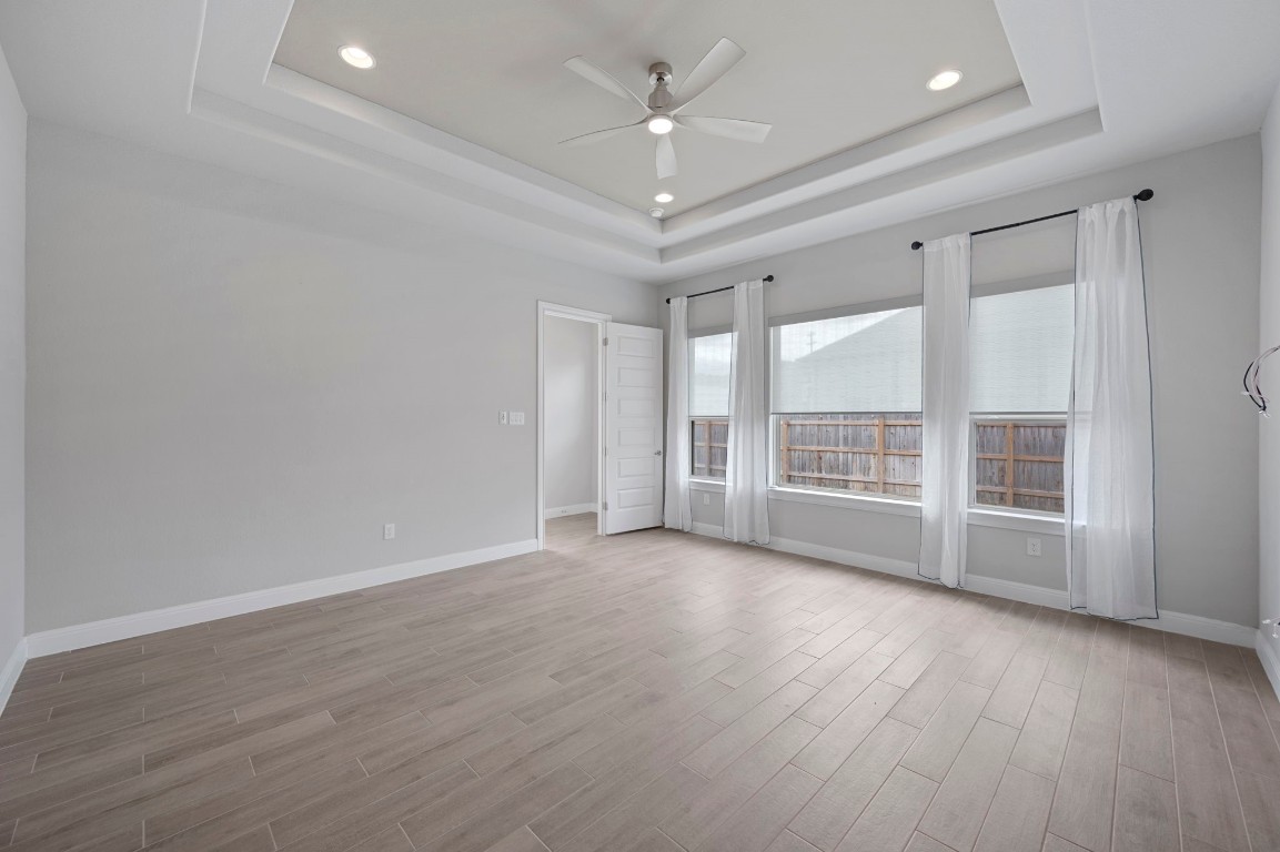 165 Eclipse Drive Austin, TX 78737 - Photo 22 of 38 wooden floor in an empty room with a window