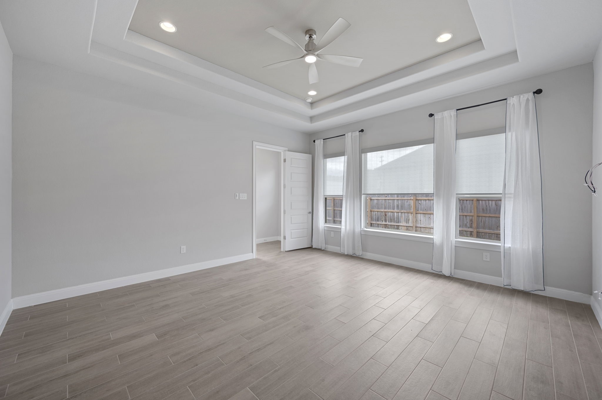 165 Eclipse Drive Austin, TX 78737 - Photo 22 of 38 wooden floor in an empty room with a window
