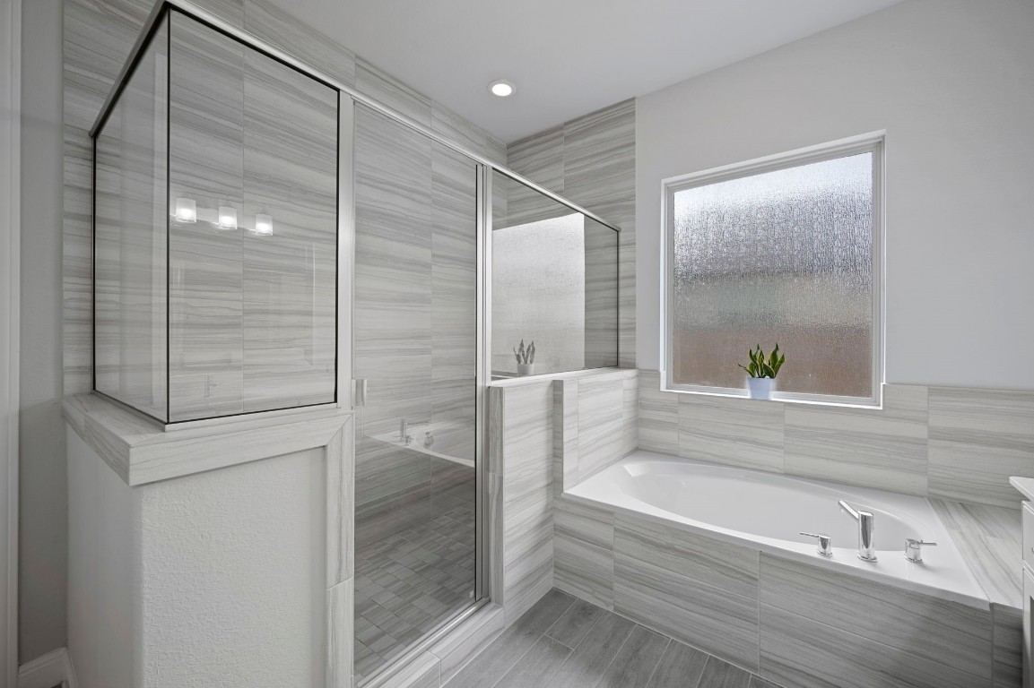 165 Eclipse Drive Austin, TX 78737 - Photo 23 of 38 a bathroom with a bathtub and a shower