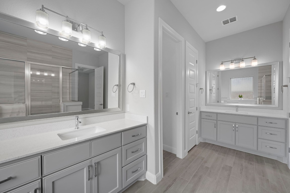 165 Eclipse Drive Austin, TX 78737 - Photo 24 of 38 a bathroom with a sink double vanity granite tub shower and a mirror