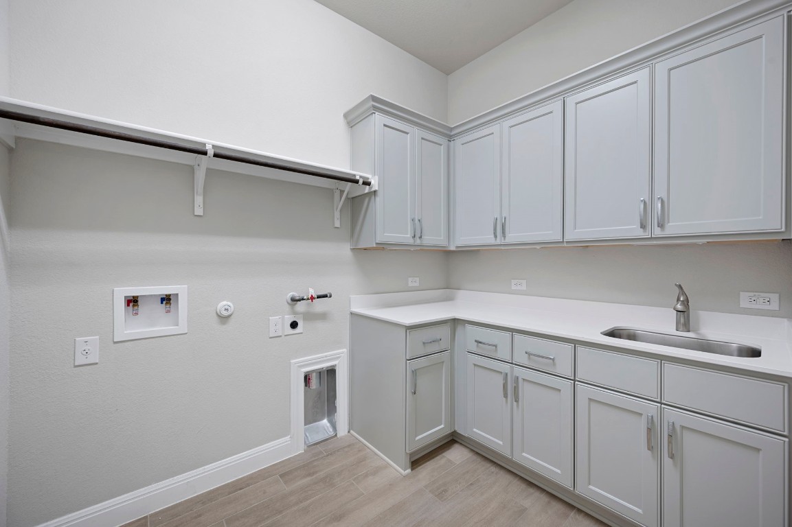 165 Eclipse Drive Austin, TX 78737 - Photo 31 of 38 a kitchen with a sink cabinets and wooden floor