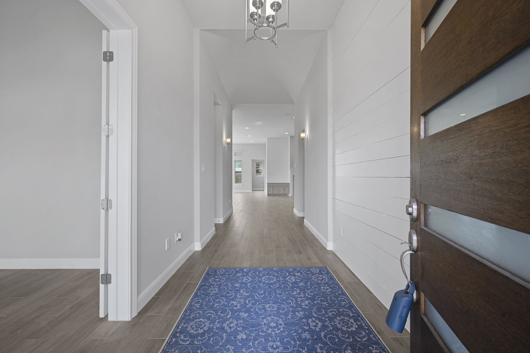 165 Eclipse Drive Austin, TX 78737 - Photo 4 of 38 a view of a hallway with a chandelier