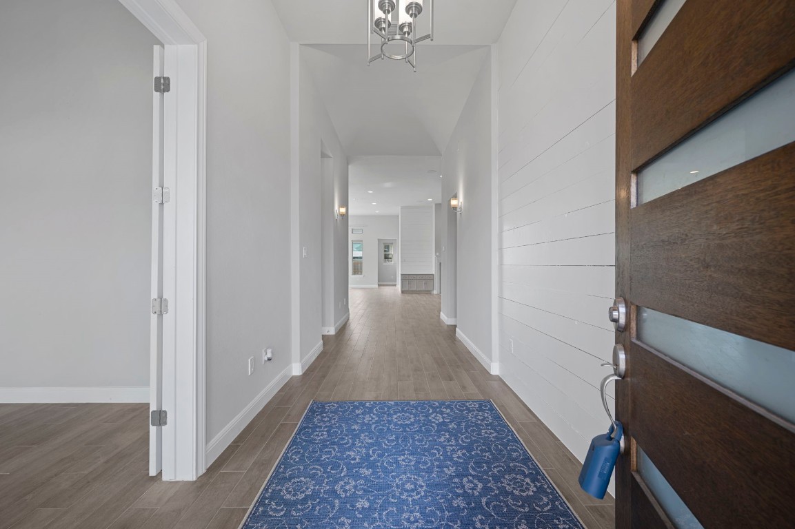 165 Eclipse Drive Austin, TX 78737 - Photo 4 of 38 a view of a hallway with a chandelier