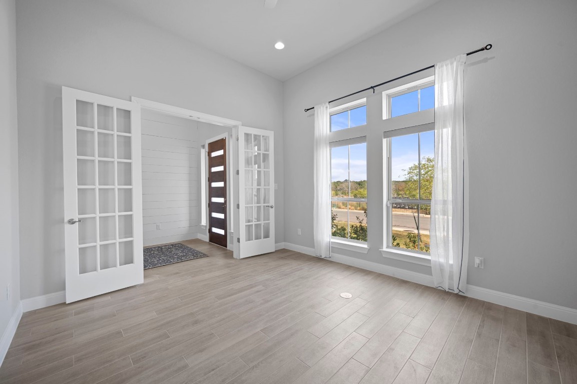 165 Eclipse Drive Austin, TX 78737 - Photo 6 of 38 an empty room with wooden floor and windows