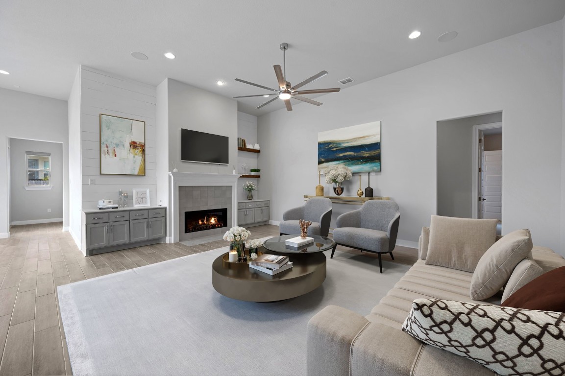 165 Eclipse Drive Austin, TX 78737 - Photo 8 of 38 a living room with furniture a flat screen tv and a fireplace