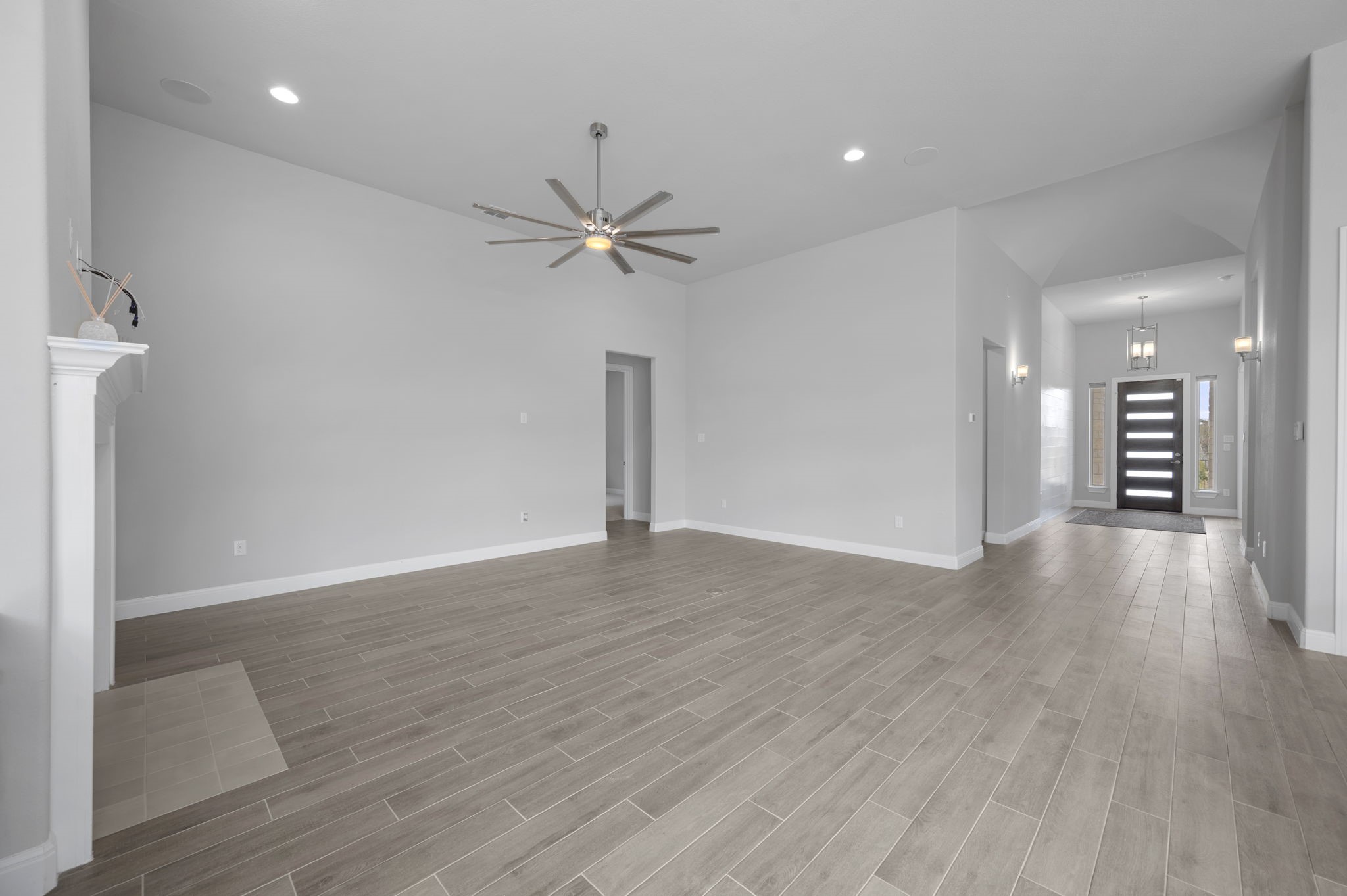 165 Eclipse Drive Austin, TX 78737 - Photo 10 of 38 a view of an empty room with wooden floor and a ceiling fan