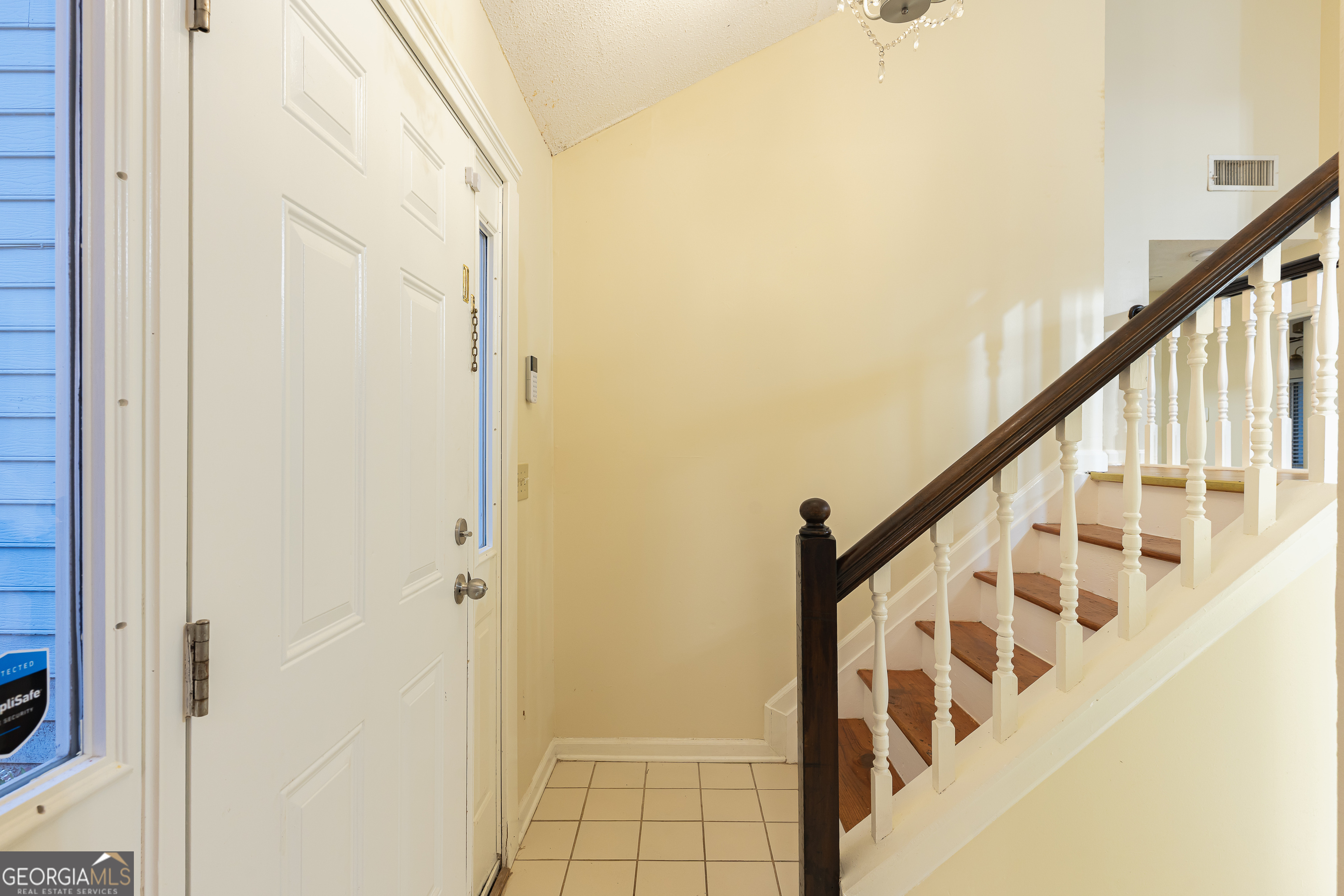 3821 Rex Mill Square Rex, GA 30273 - Photo 4 of 51 a view of staircase with wooden floor and white walls