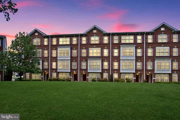 a front view of a building with a yard