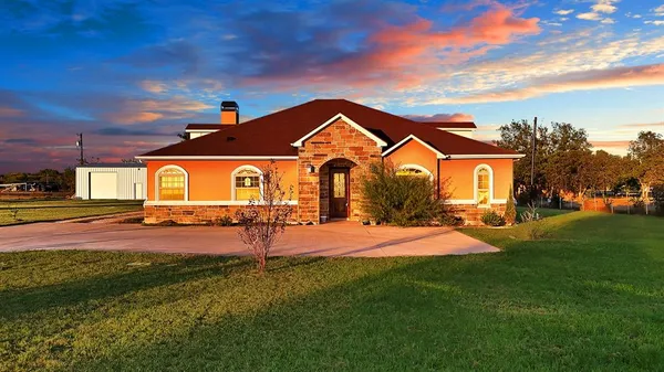a front view of a house with a big yard
