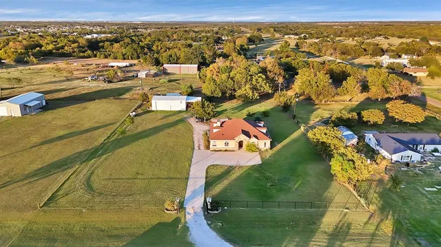 an aerial view of residential houses with outdoor space
