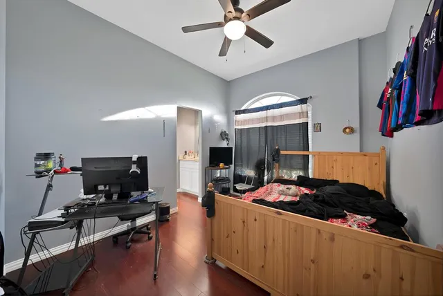 a bedroom with furniture and a flat screen tv