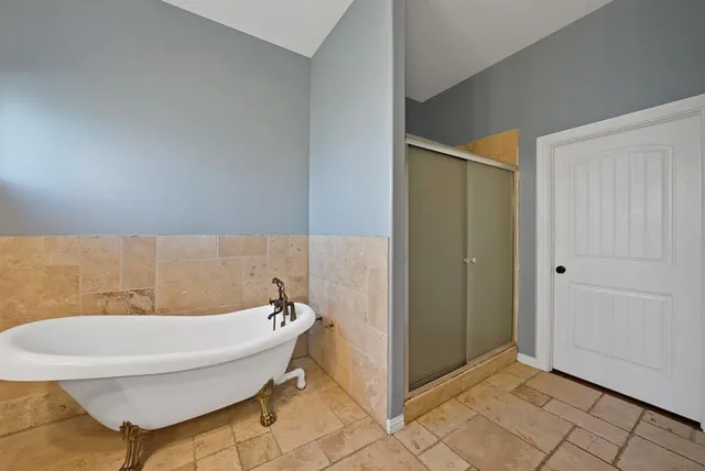 a bathroom with a tub and shower