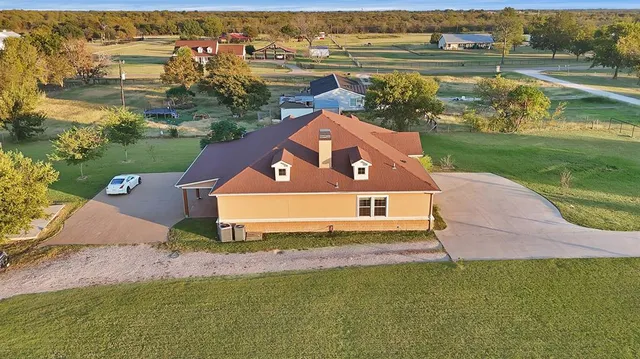 an aerial view of a house with outdoor space and lake view