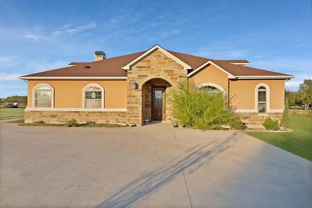 a front view of a house with yard