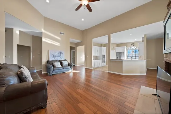 a living room with furniture and a wooden floor
