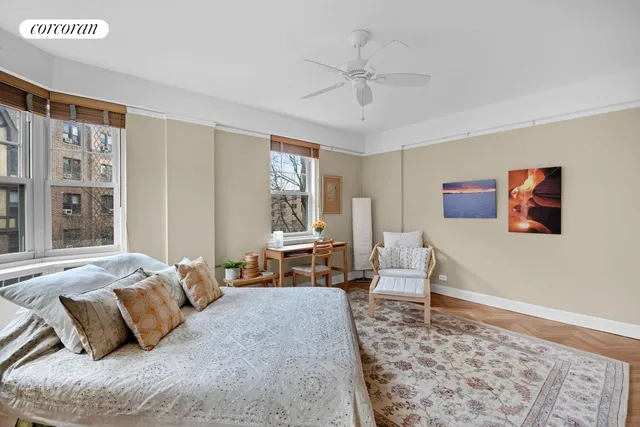 a bedroom with a bed couch and a window