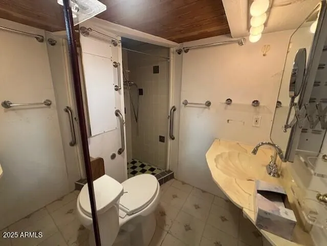 a bathroom with a sink toilet and shower