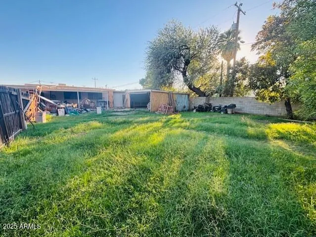 a backyard of a house with lots of green space and fountain