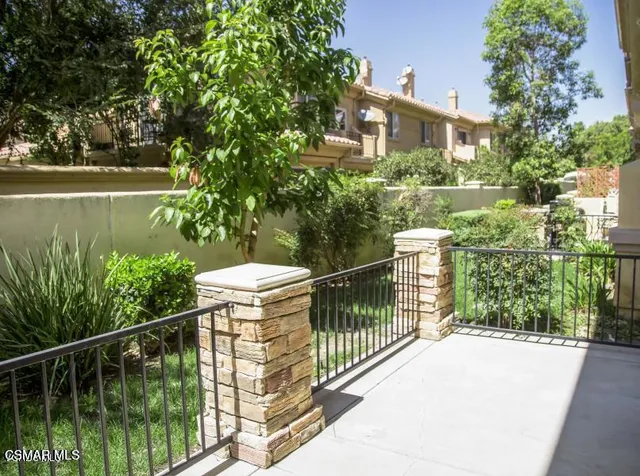 a balcony with trees in front of it