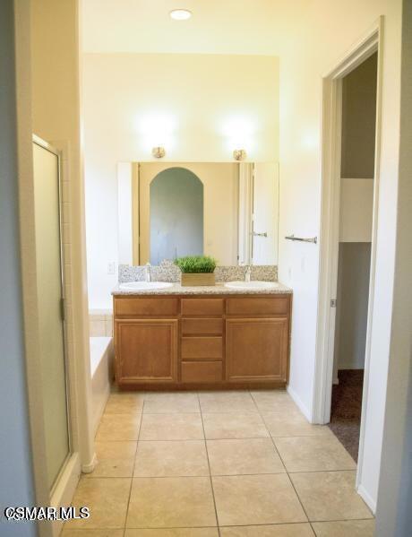 1484 Patricia Avenue, Unit 13 Simi Valley, CA 93065 - Photo 3 of 4 a bathroom with a sink a mirror and a bathtub